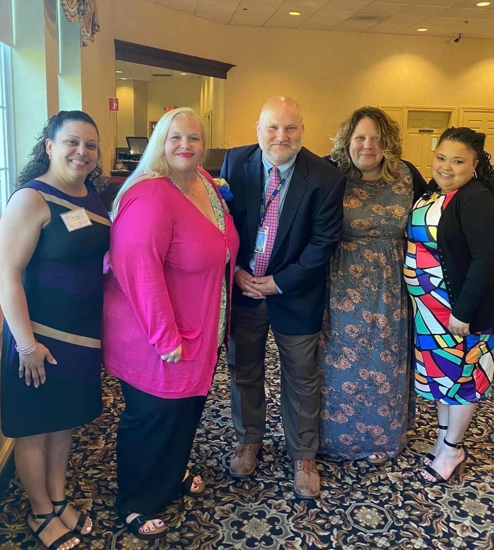 A group of people posing for a picture in a room