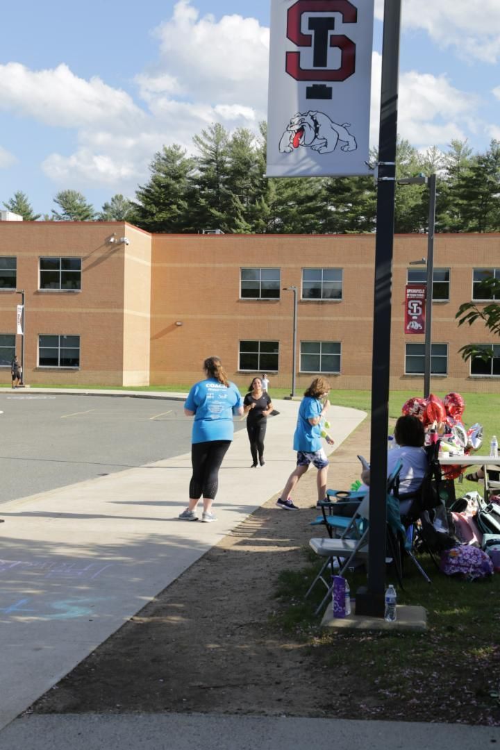 People walking in front of a building with a sign that says s.i.