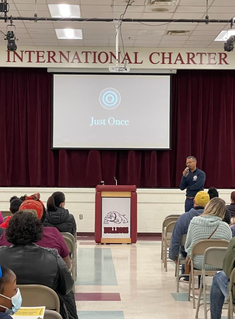 A man is giving a presentation in front of an international charter sign
