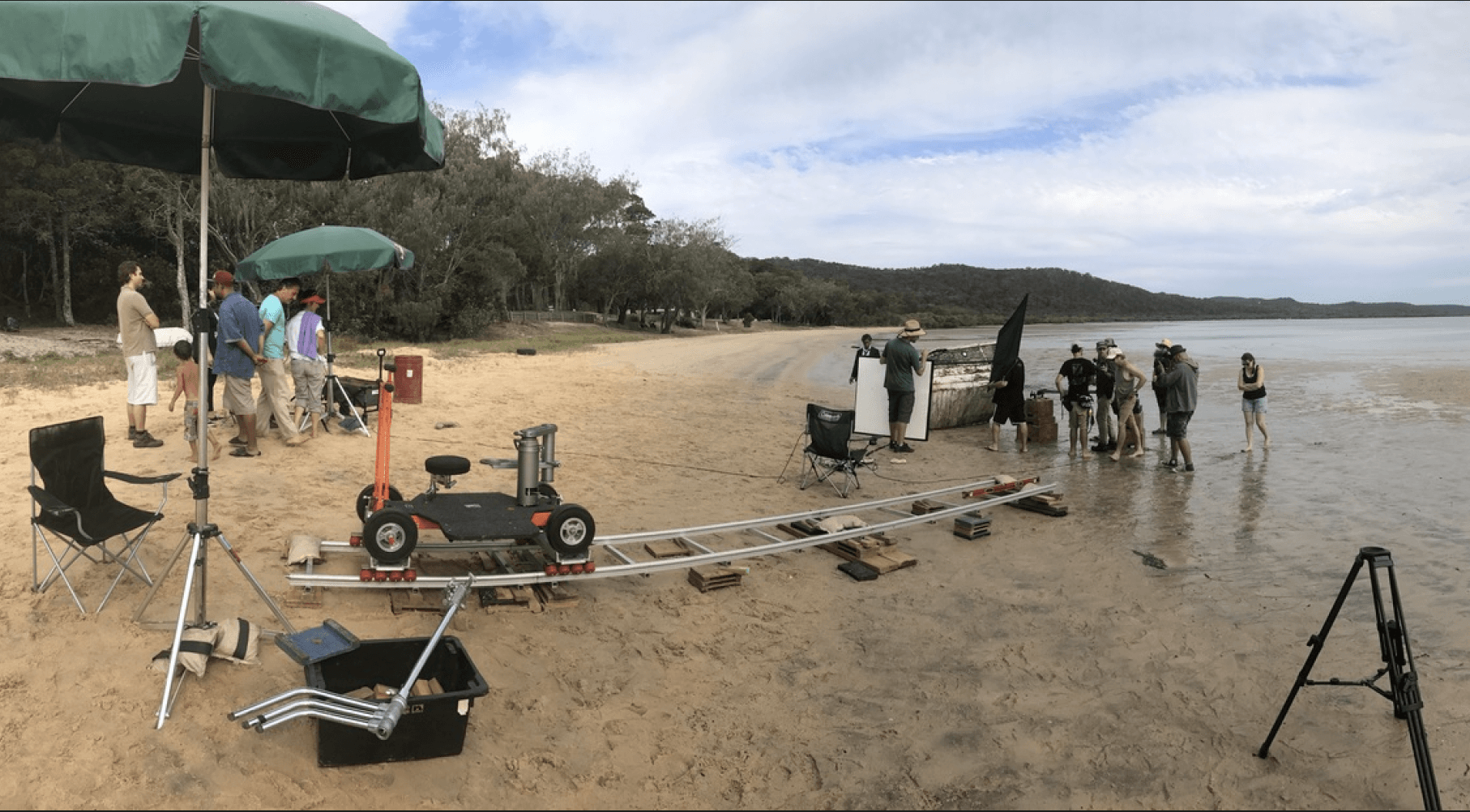 A group of people are standing on a beach.