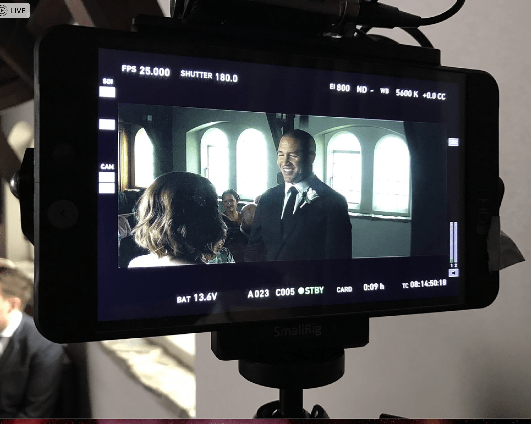 A man in a suit and tie is talking to a woman