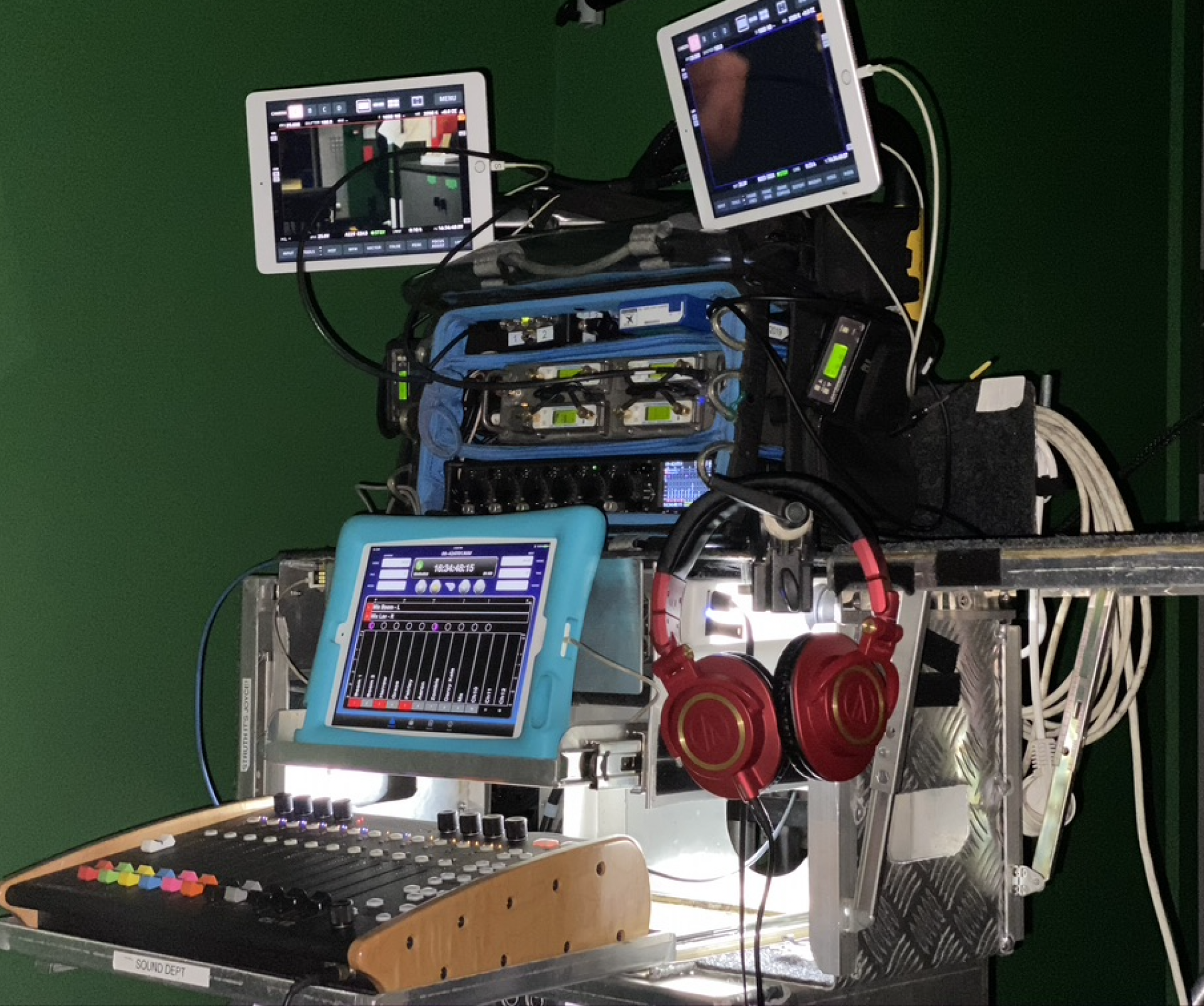 A bunch of electronic equipment including headphones and a tablet