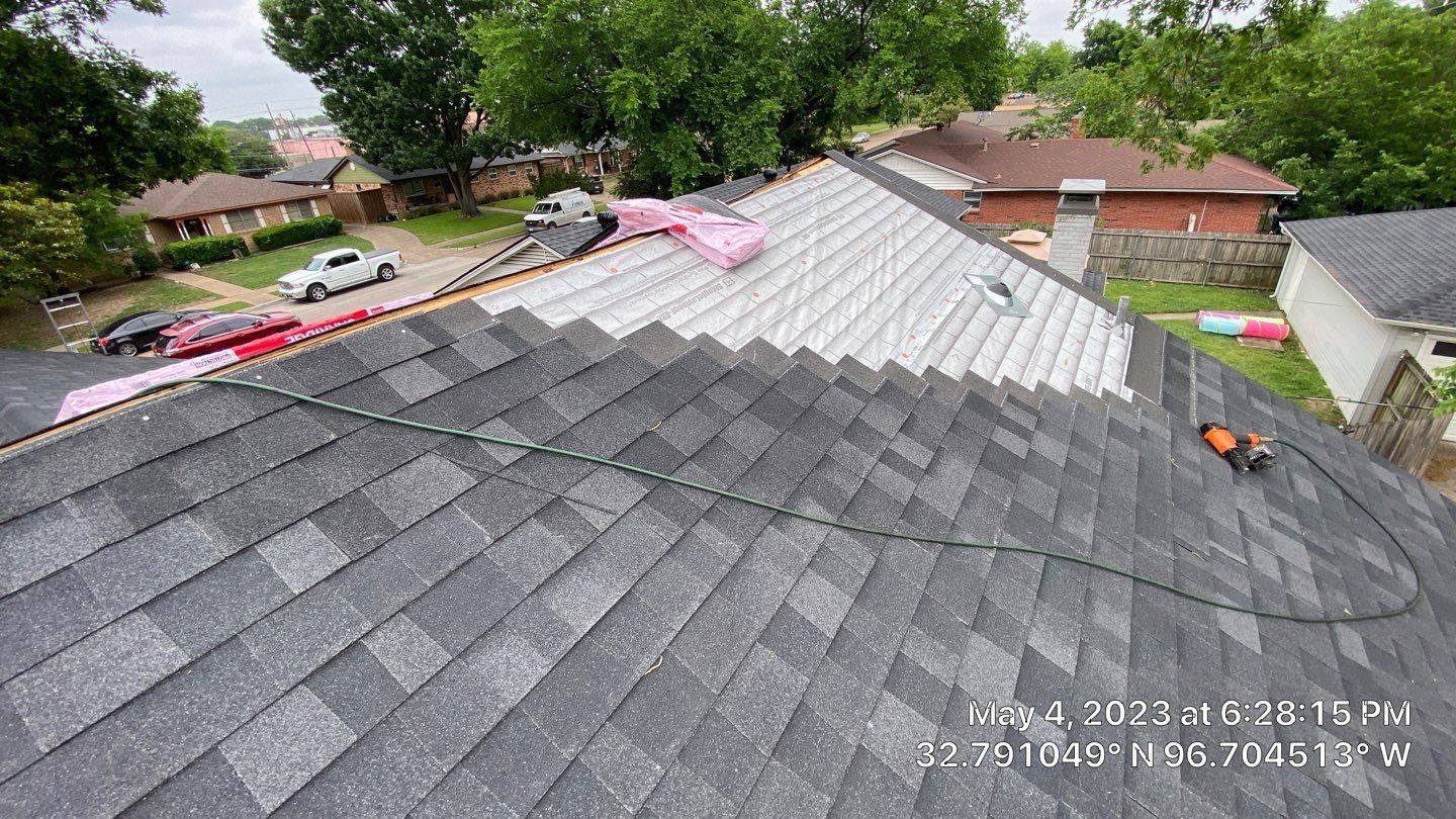 Roof with gray shingles partially replaced, construction in progress.