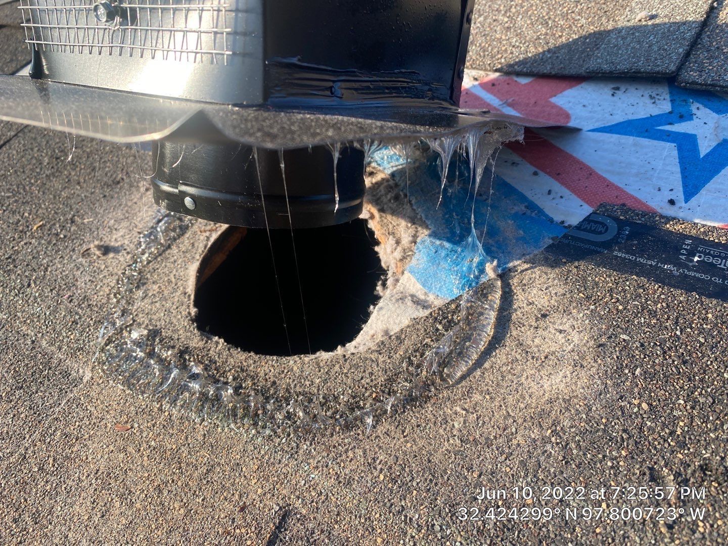 Close-up of a roof vent with ice crystals around it; hole in the roof visible.