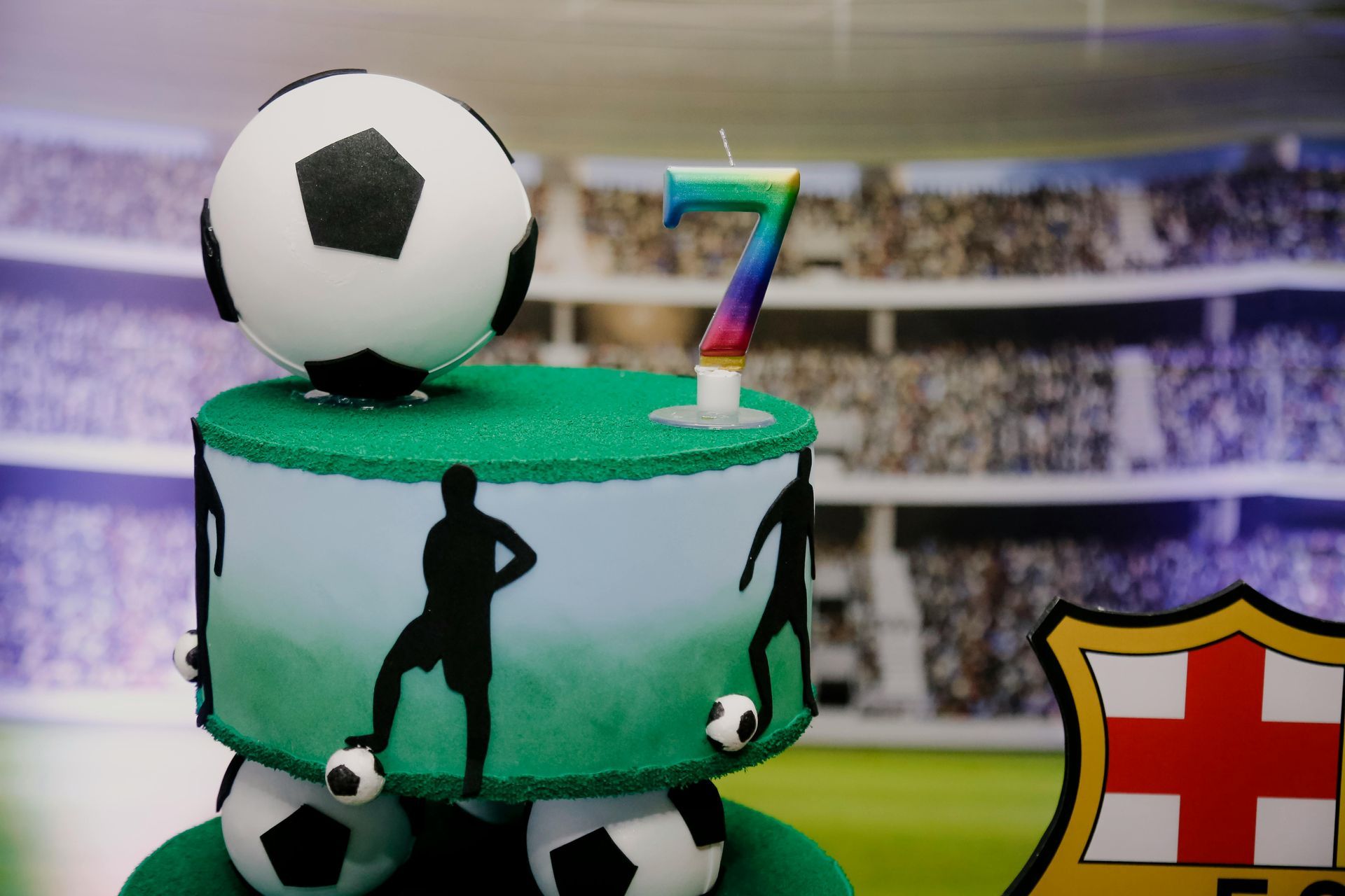 Soccer-themed birthday cake with a soccer ball topper,