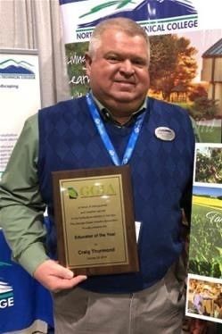 Swimming pool with white pergola, palm trees, and a building in the background.