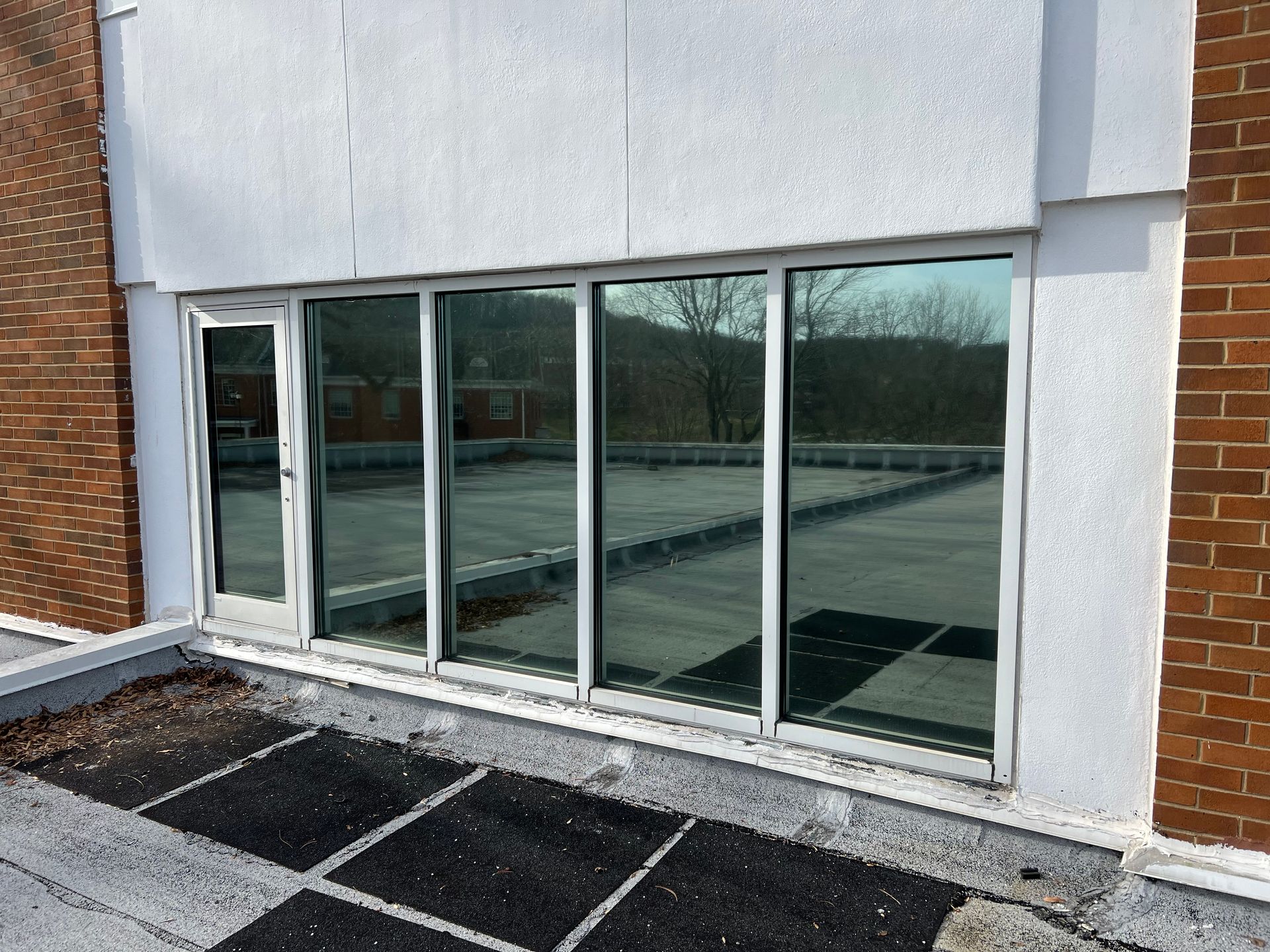 A building with a lot of windows and a brick wall