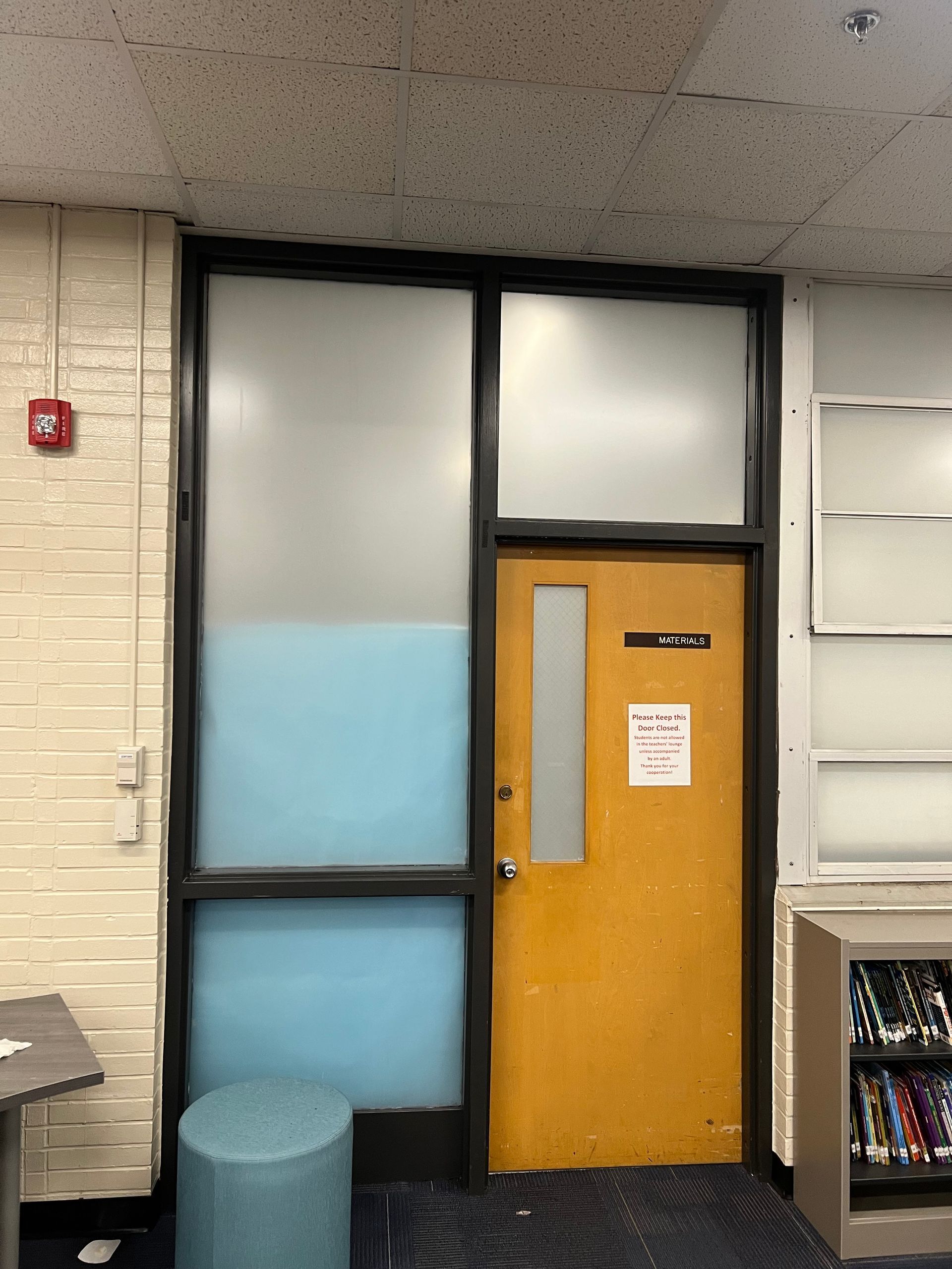 A yellow door with a sign on it that says ' emergency exit '