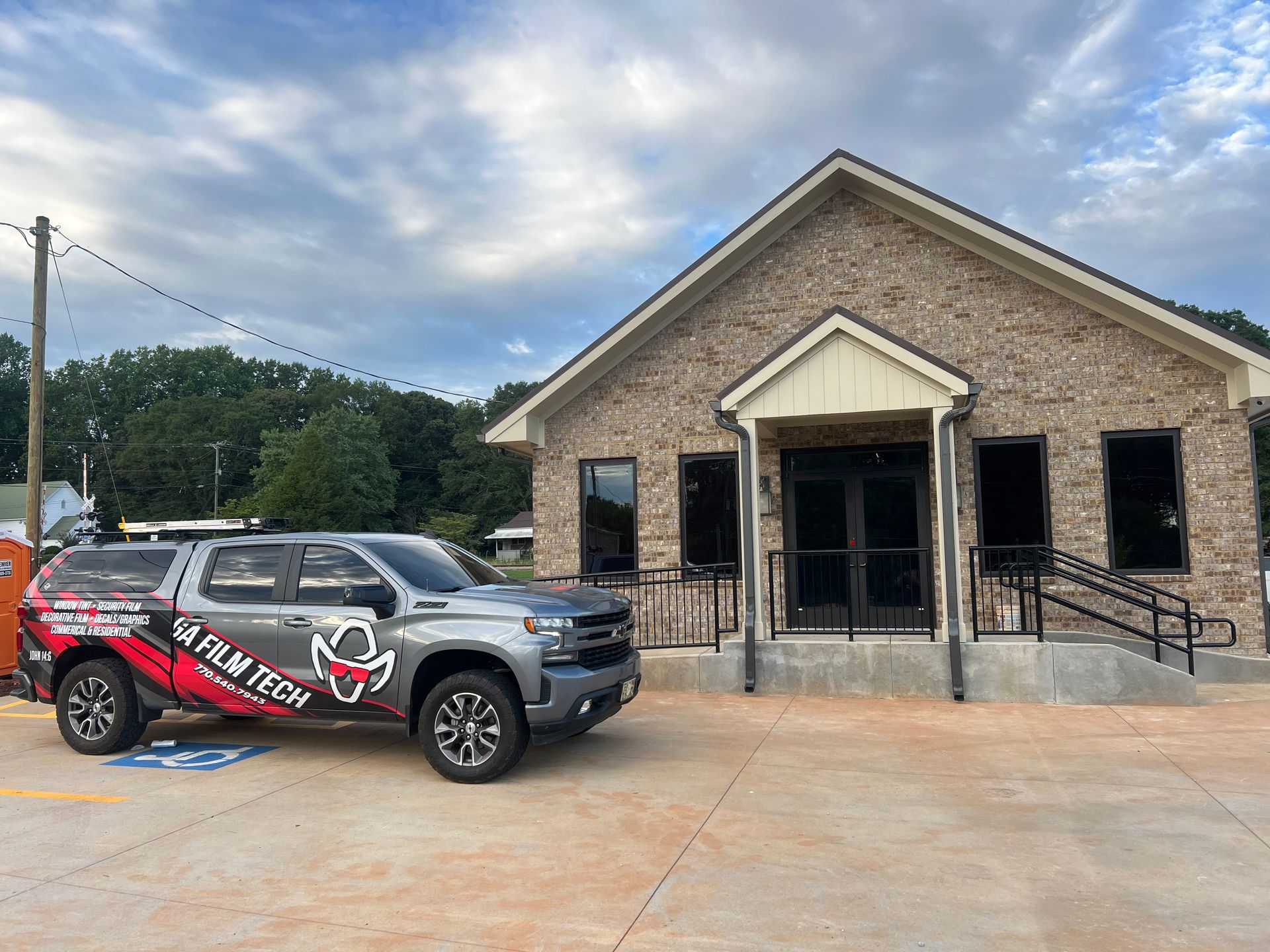 A truck is parked in front of a brick building.