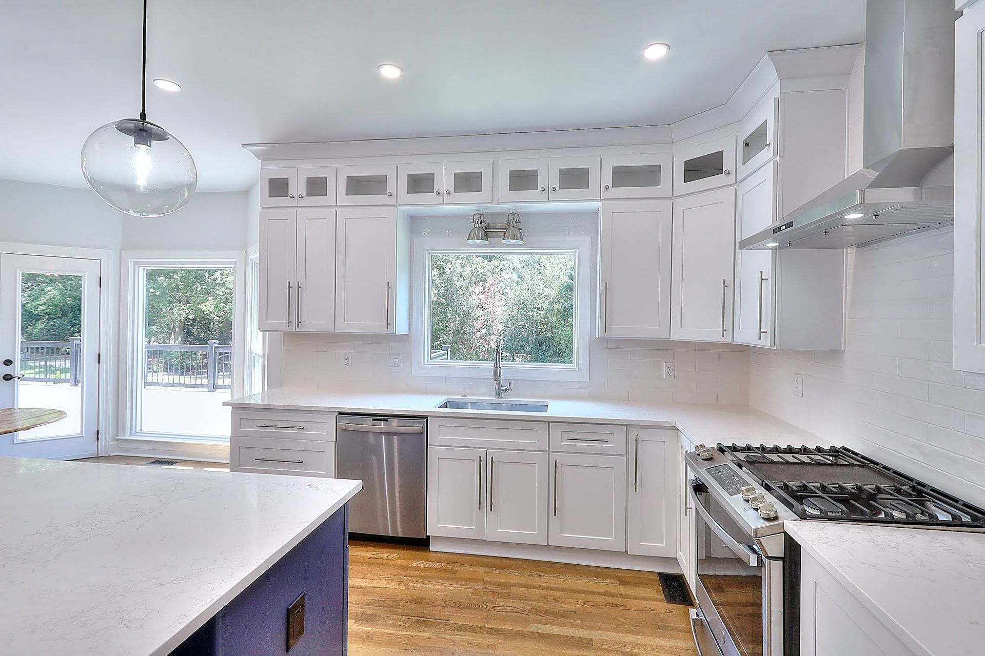 A kitchen with white cabinets and stainless steel appliances