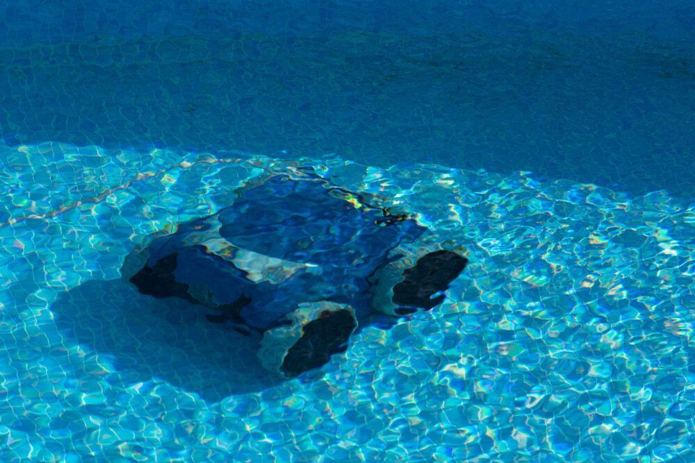 Pool Cleaner Robot Submerged in a Blue Swimming Pool — Dean Thomas Pools in Tablelands, QLD