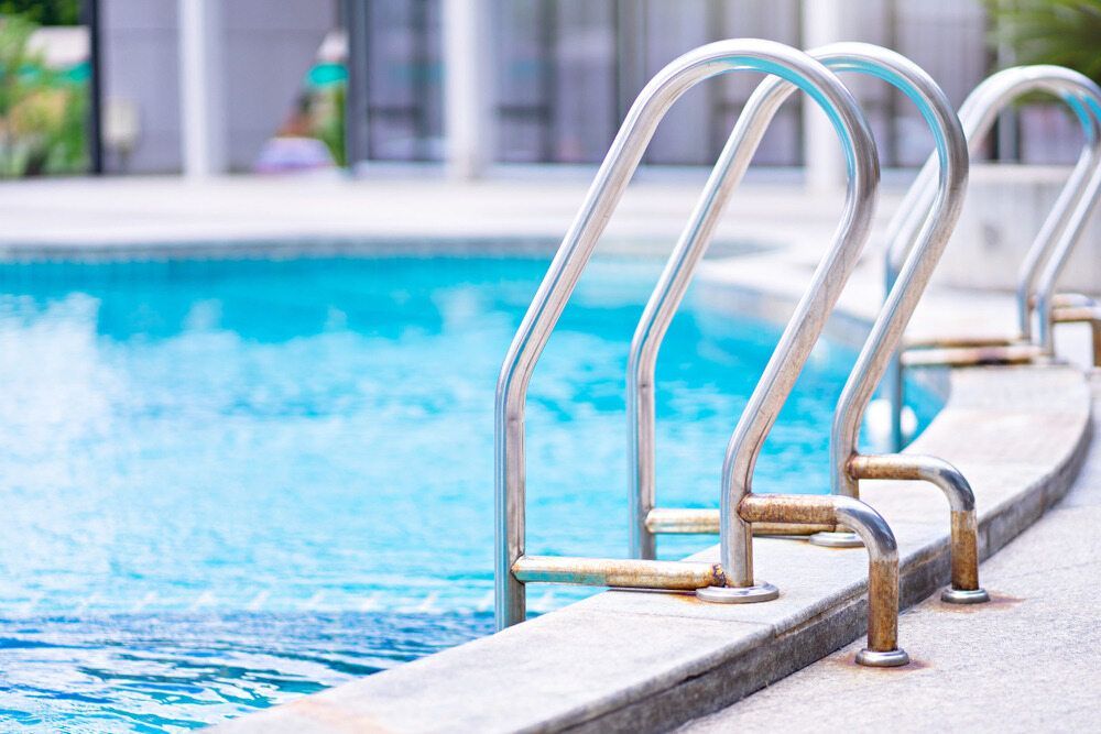 Pool With Metallic Ladder, Turquoise Water — Dean Thomas Pools in Manunda, QLD
