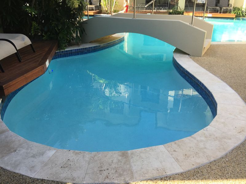Pool With a Bridge, Blue Water, White and Blue Tile Edging — Dean Thomas Pools in Manunda, QLD