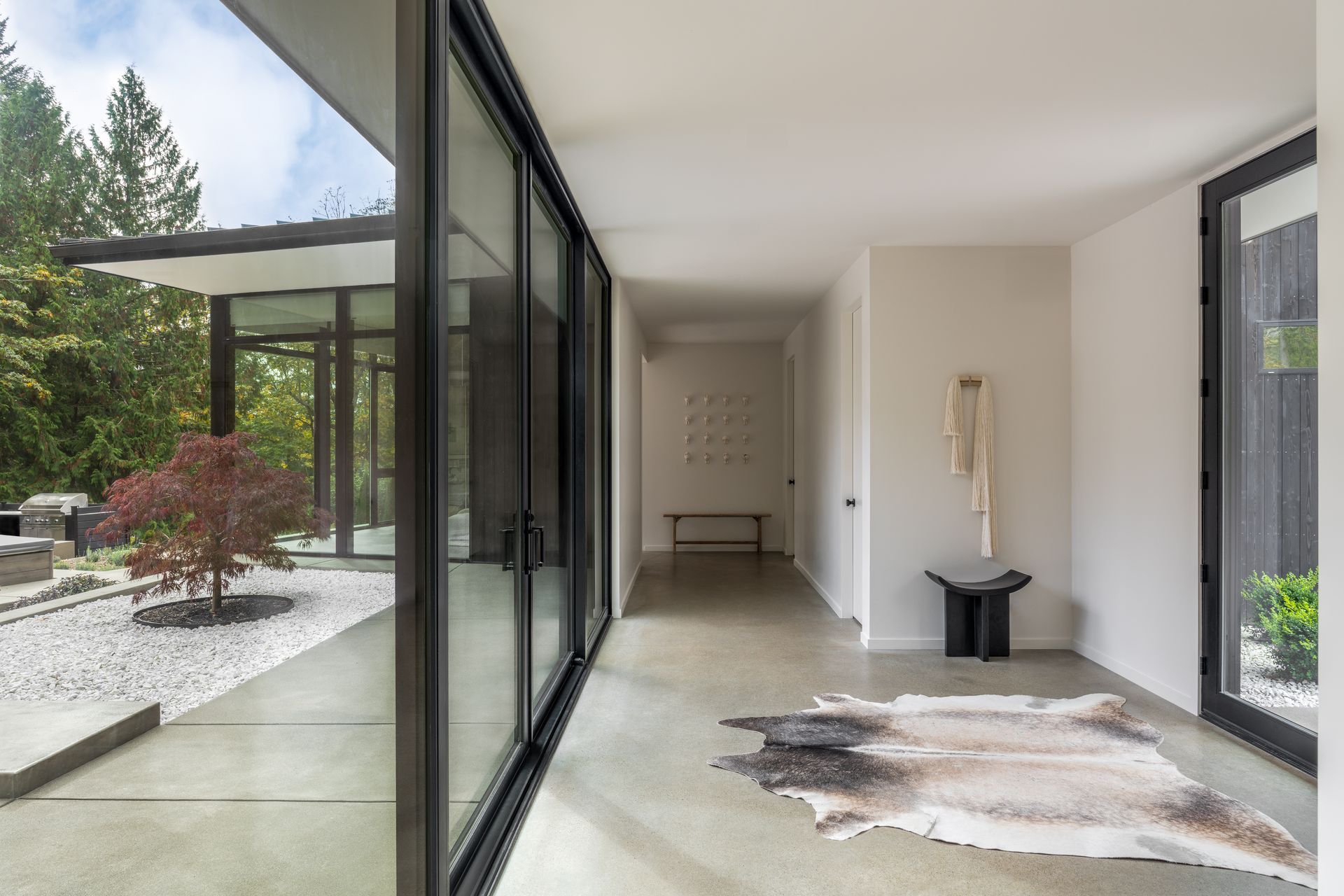 Modern house hallway with cowhide rug by Davis Studio Architects. Emily Barrows Photography.