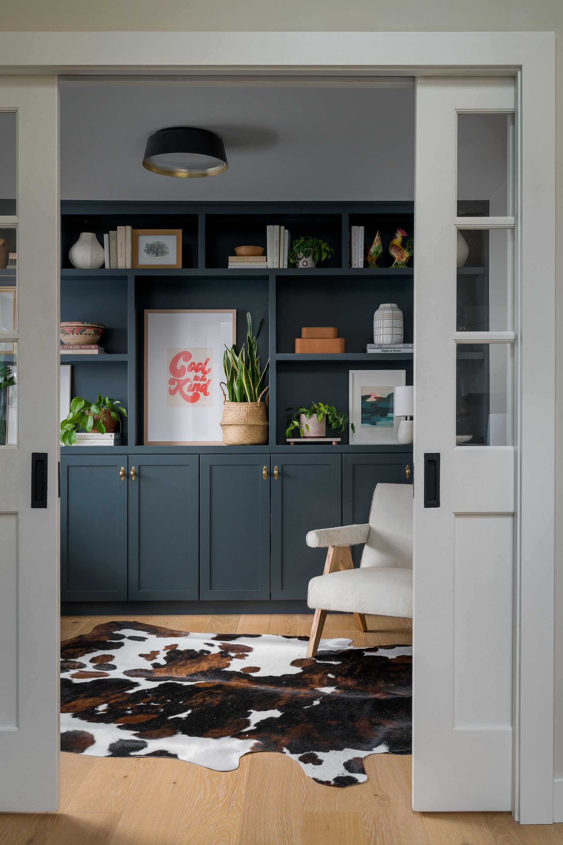 A living room with a cowhide rug and sliding glass doors in Seattle, WA.