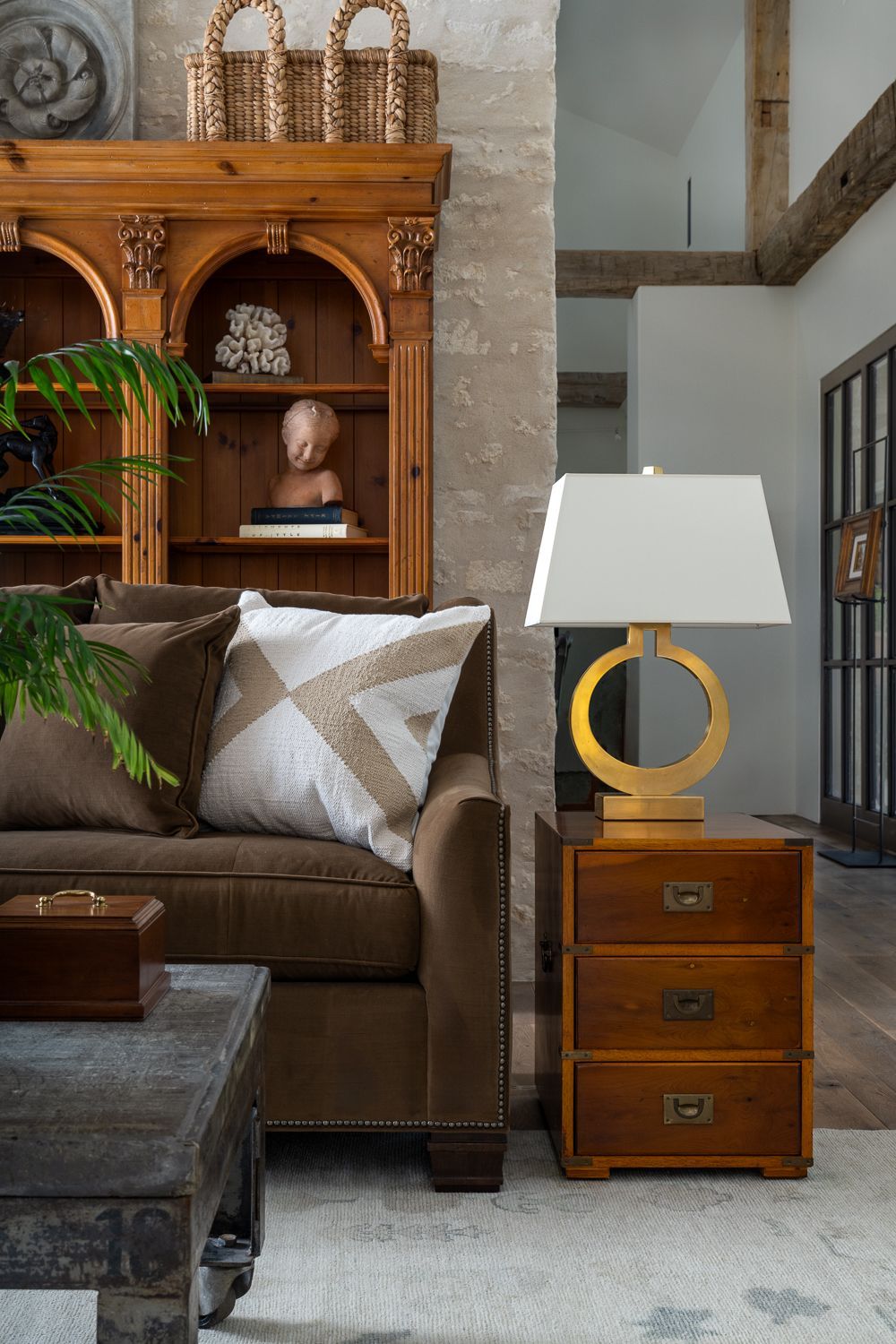 A living room with a couch , table , lamp and dresser in Blanco, TX. Photography by Emily Barrows Photography.