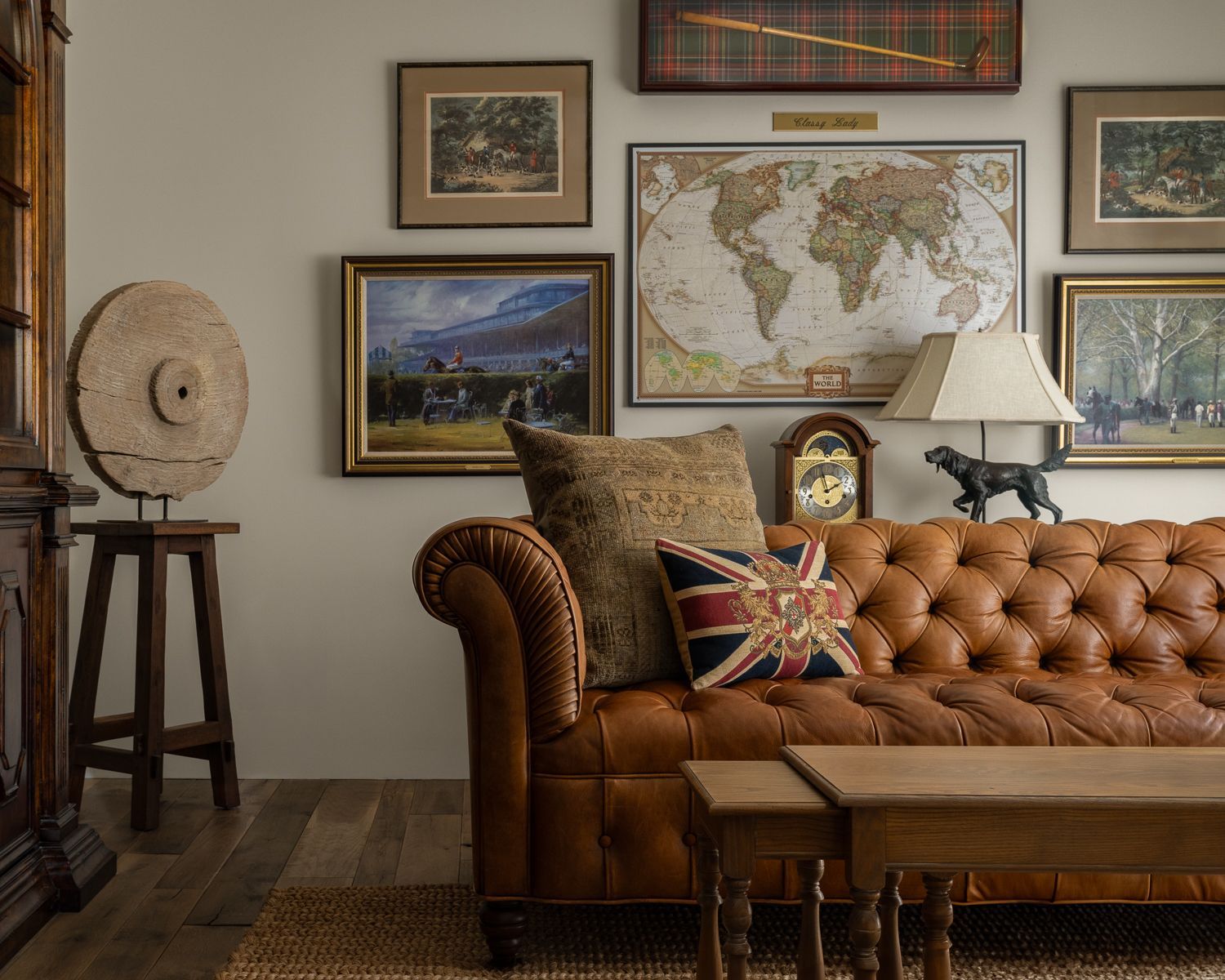 A living room with a brown leather couch and a map of the world on the wall. Emily Barrows Photography. Blanco, TX.