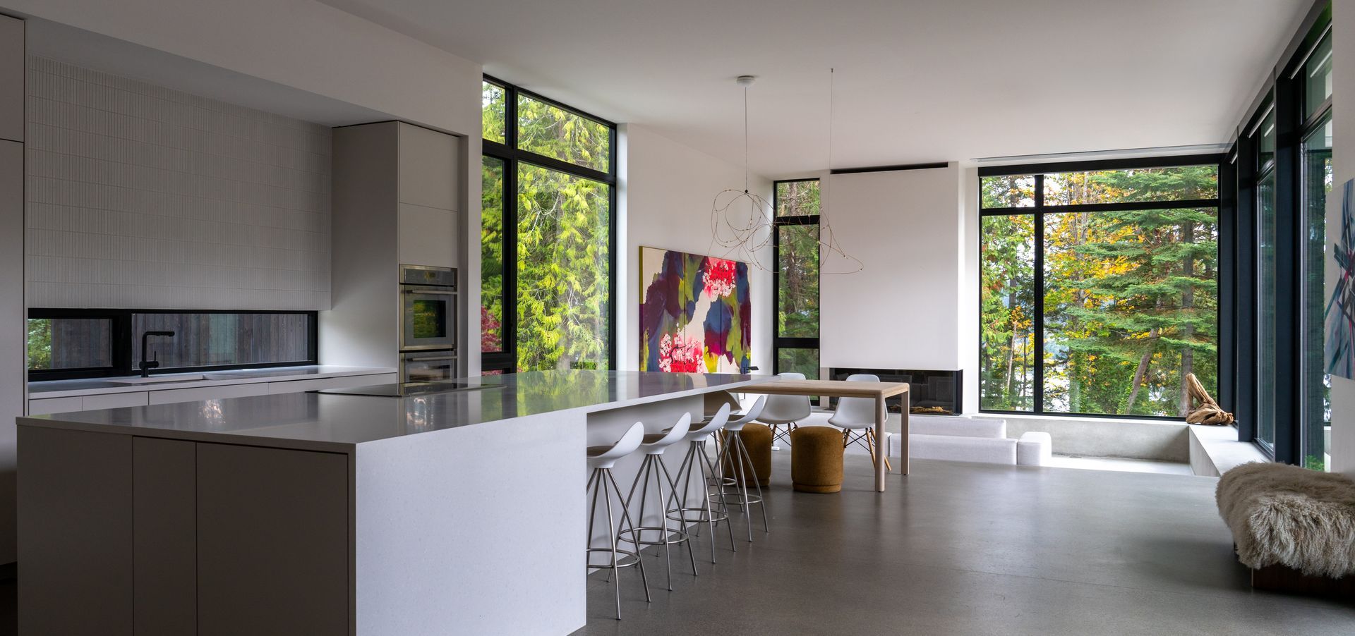 A kitchen and dining room in a house with lots of windows.  Photography by Emily Barrows Photography. Davis Studio Architects