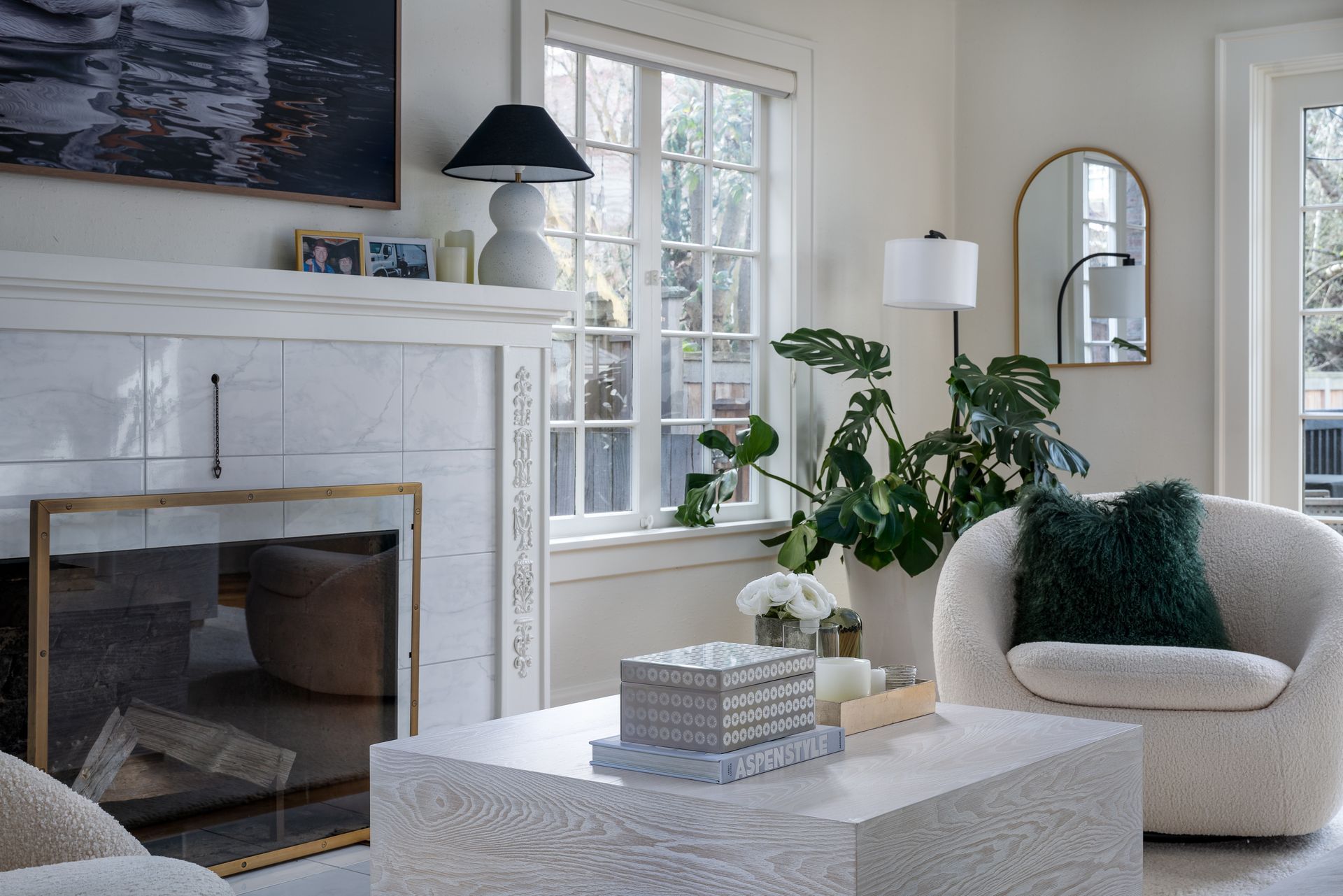 A living room with a fireplace , two chairs , a coffee table and a lamp in Seattle, WA.  Emily Barrows Photography.