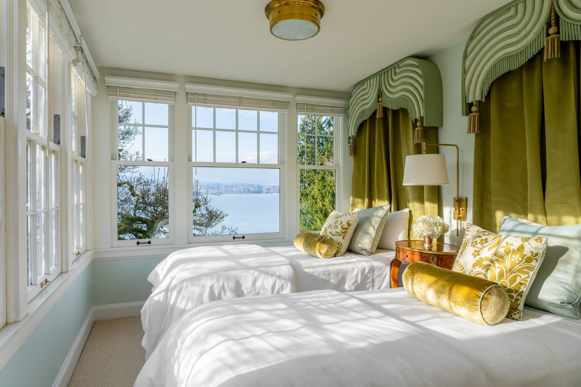 A bedroom with three beds and a view of Lake Washington in Seattle.
