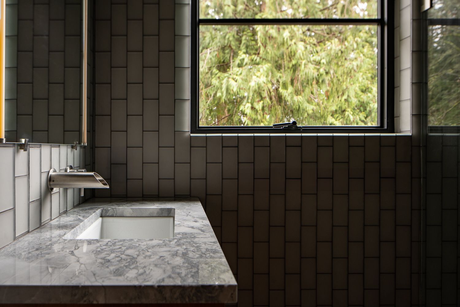 A bathroom with sink , mirror , and window. Wenzlau Architects. Emily Barrows Photography. Bainbridge Island, WA. 