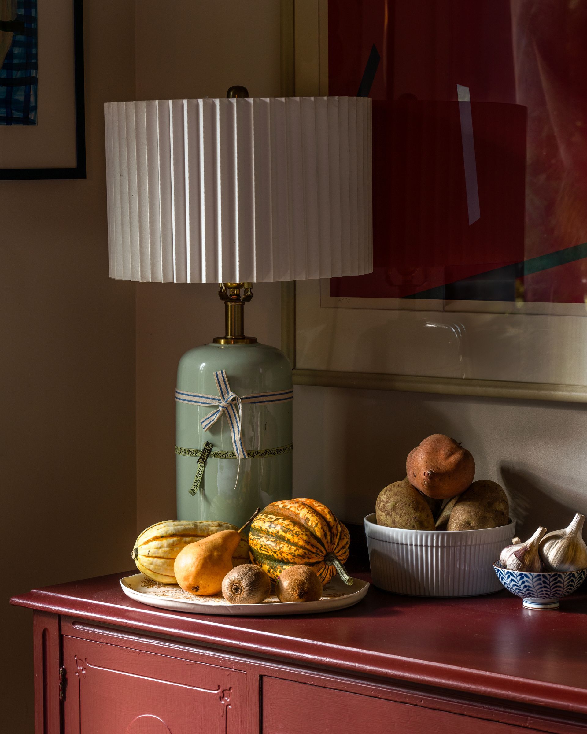A lamp is sitting on a table next to a bowl of fruit. Bainbridge Island, WA. Photography by Emily Barrows Photography. 