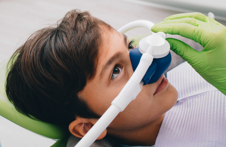 child with sedation mask on | pediatric and family dentist in Waterford mi