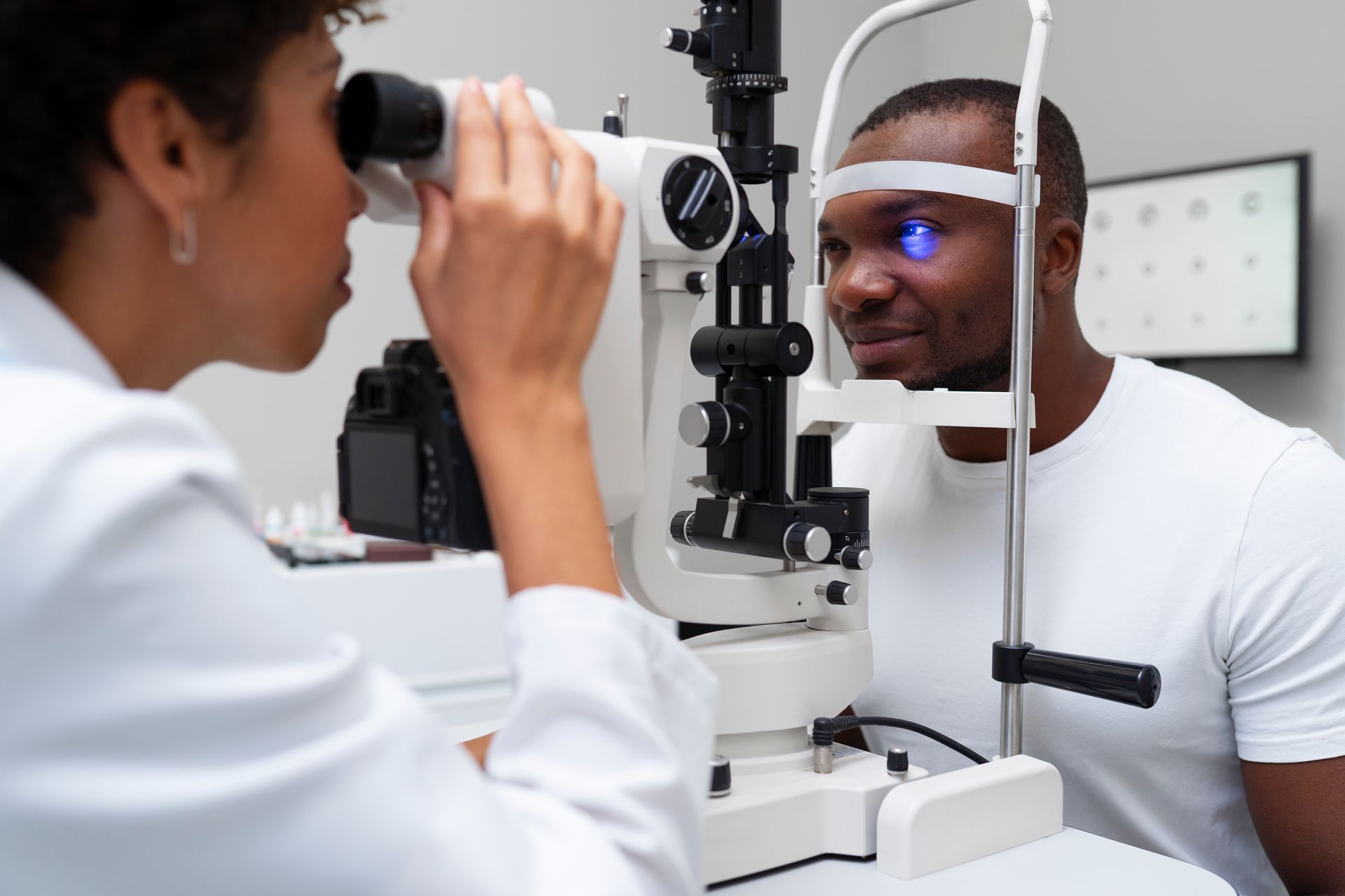 A man is getting his eyes examined by an ophthalmologist.