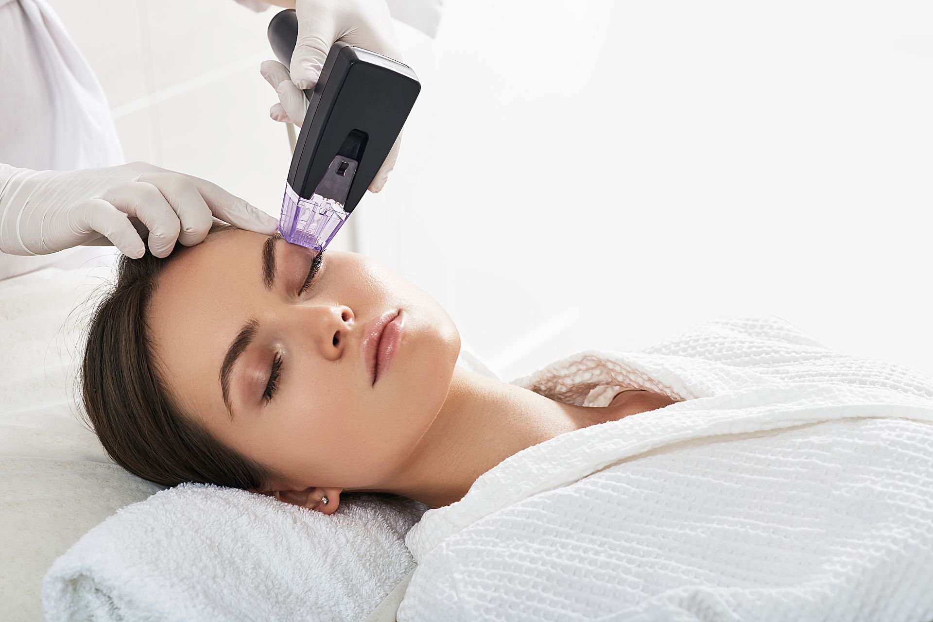 A woman is getting a facial treatment at a spa.