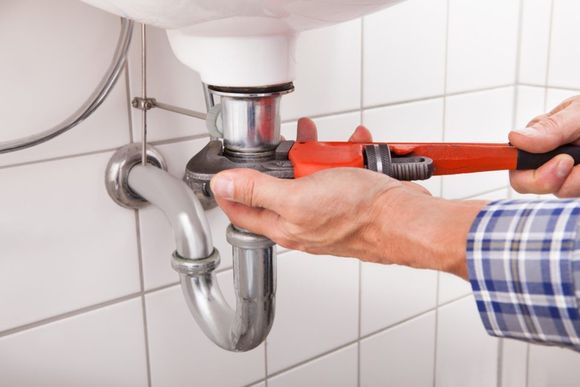 plumber changing the  sink pipe