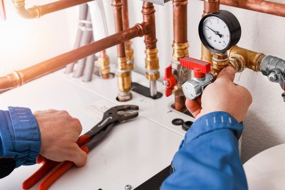 plumber checking the pressure gauge