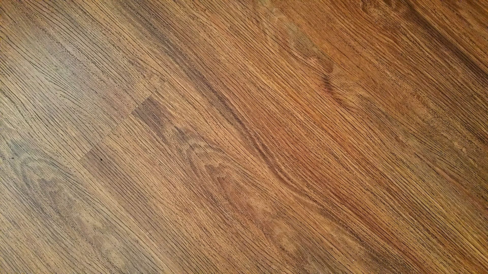 Close-up of a brown wood-grain surface with diagonal streaks