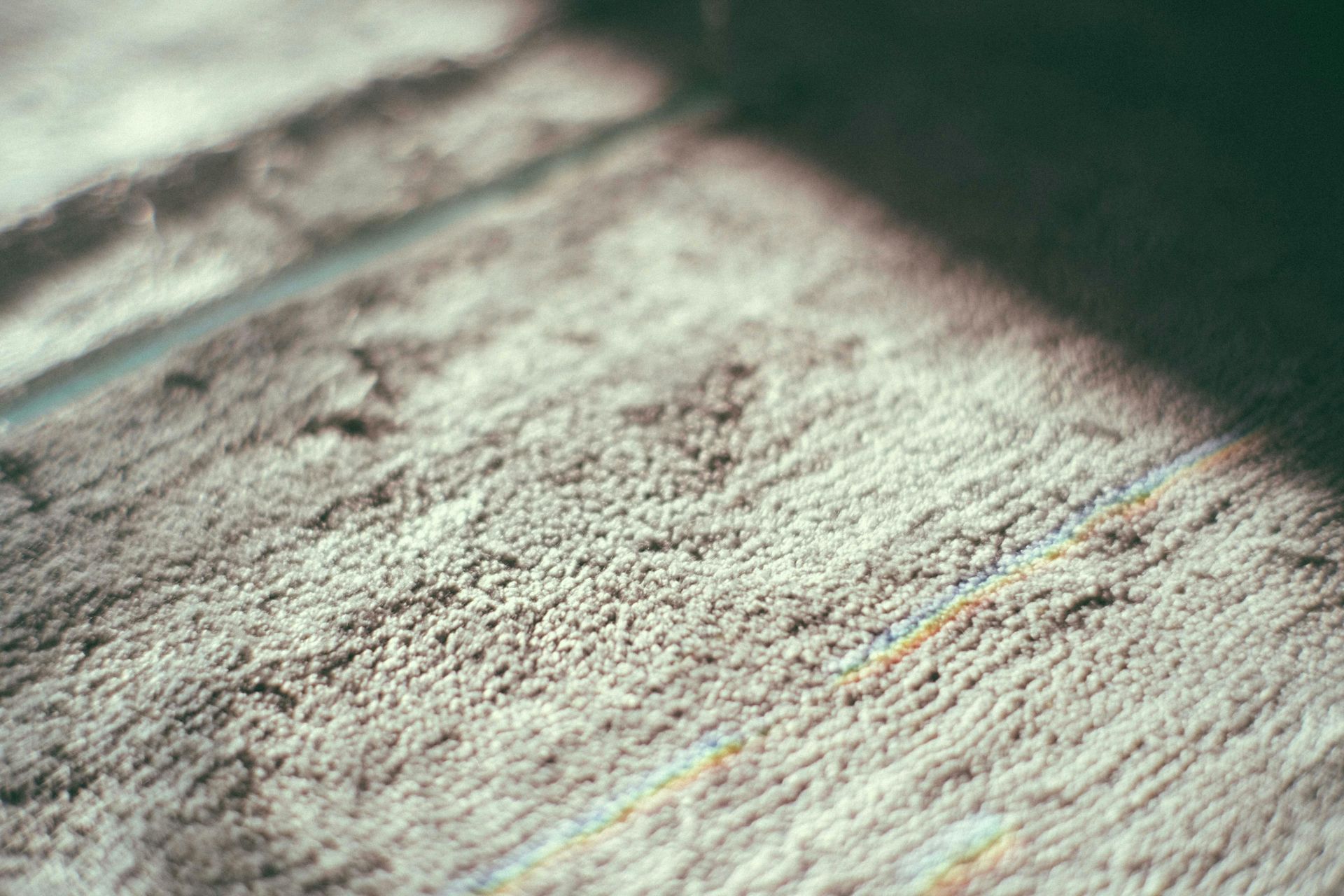 Close-up of a textured surface with sunlight and shadow bands