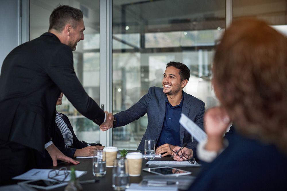 A Man Shakes Hands With Another Man — Workplace Conflict Resolution in Kingscliff, NSW