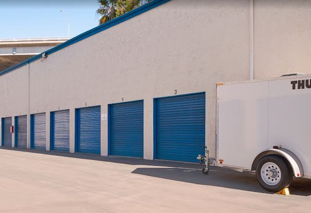 A close up of a lock on a blue storage unit door.