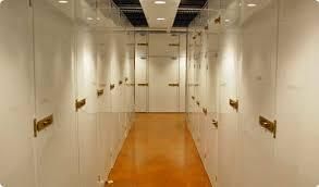 A long hallway filled with white cabinets and a wooden floor.