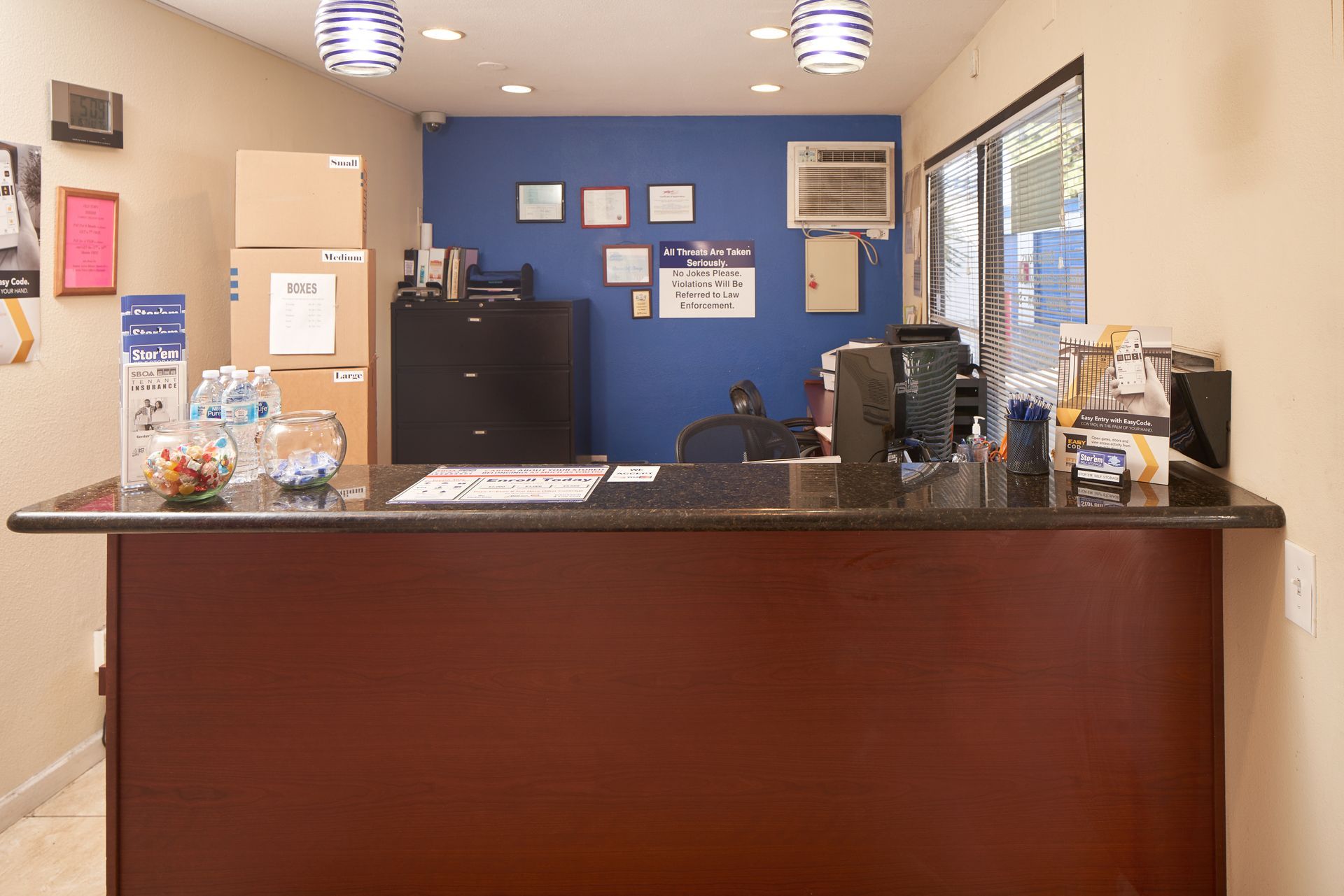 A reception desk in a hotel with boxes on the wall
