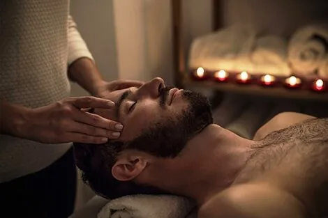 A man is getting a head massage in a spa.
