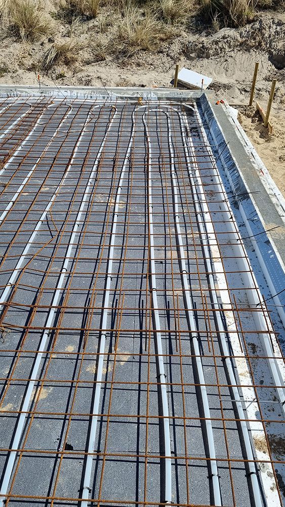 Et nærbillede af et betongulv med et trådnet.