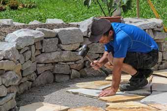 Contractor breaking stone for patio - Patios in Waynesboro, PA