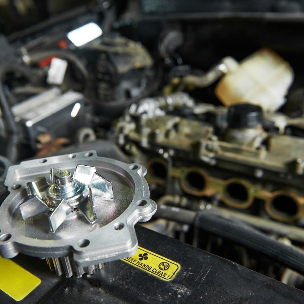 A close up of a water pump in a car engine