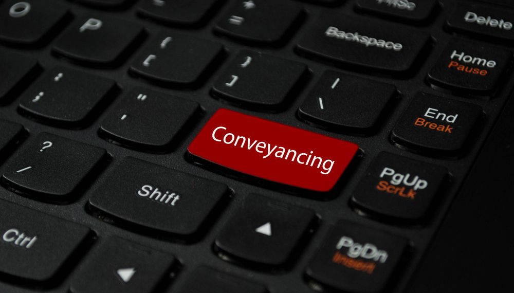 A Black Keyboard with A Red Button that Says Conveyancing — A M Conveyancing Pty Ltd In Tweed Heads, NSW