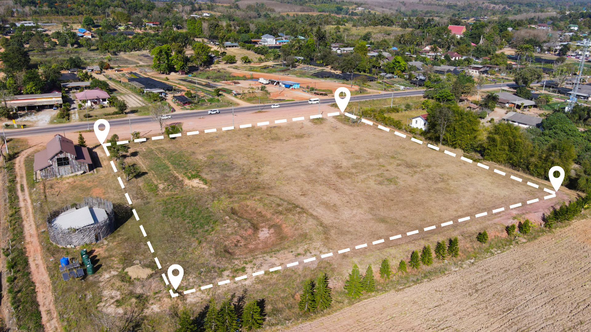 an aerial view of a field with a white line drawn around it .