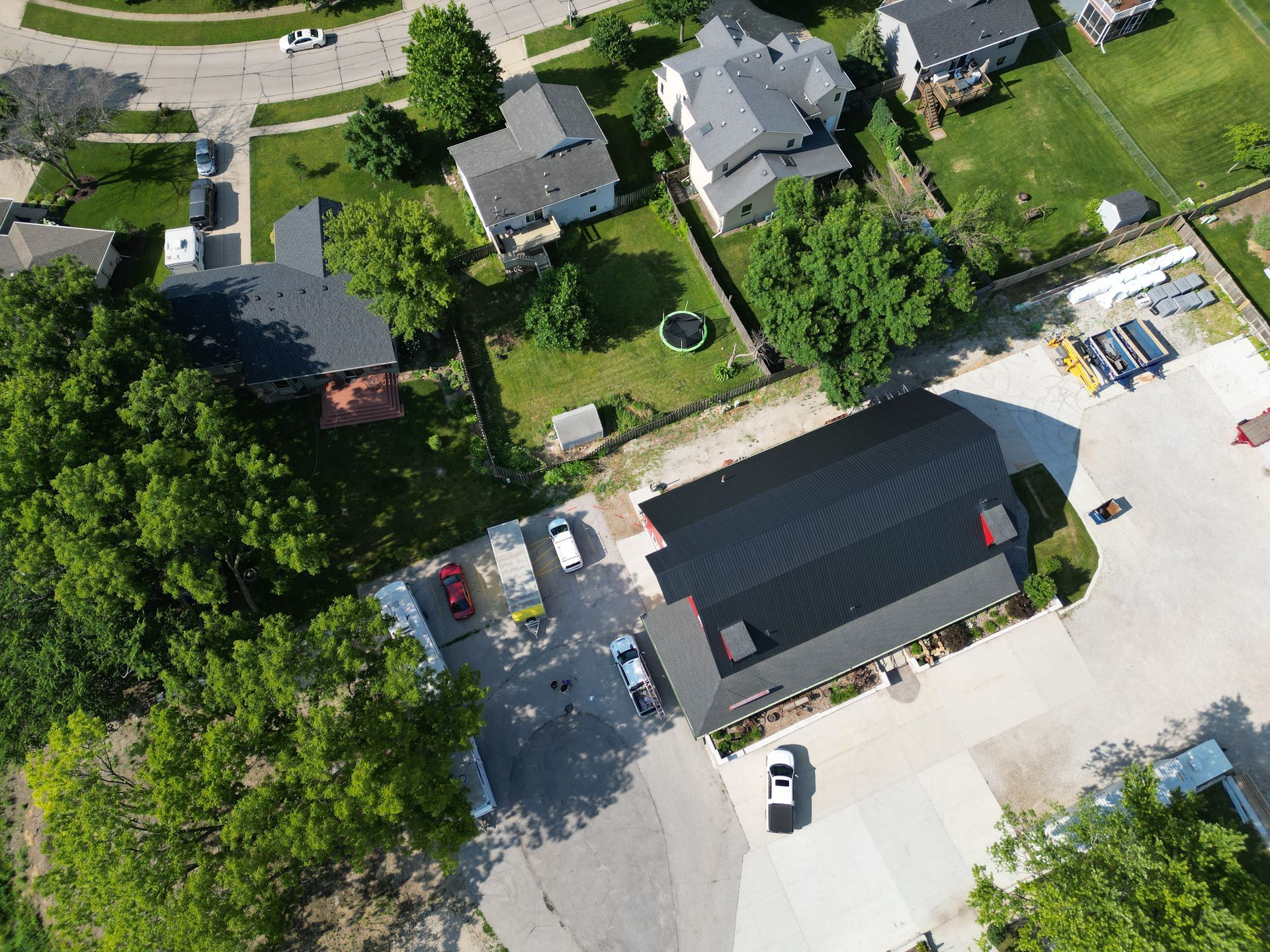 An aerial view of a residential area with houses and trees