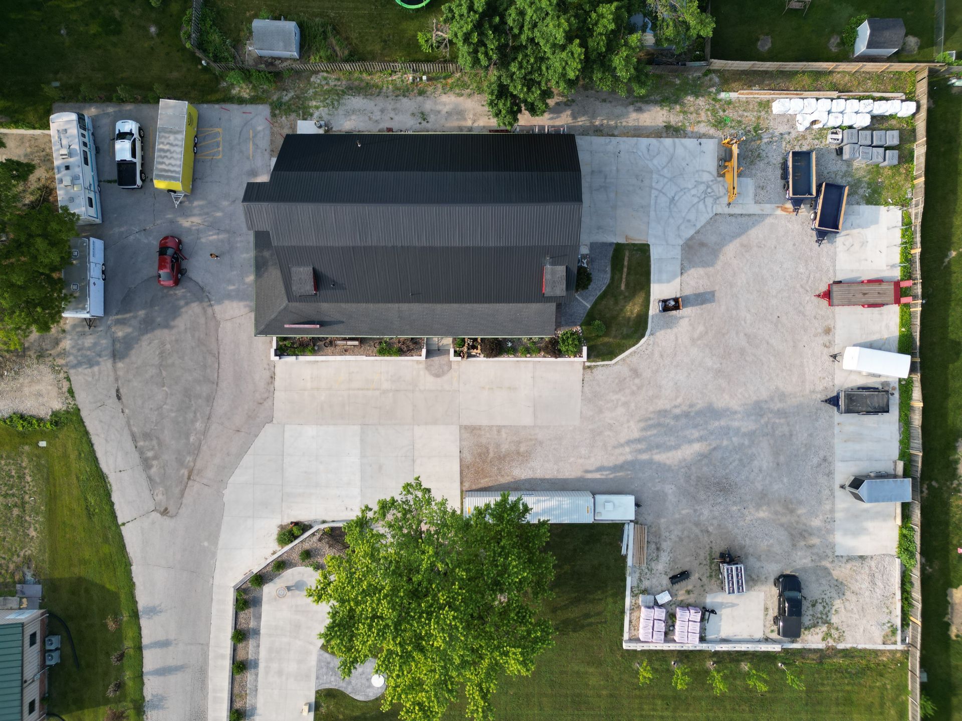 An aerial view of a house and a parking lot.