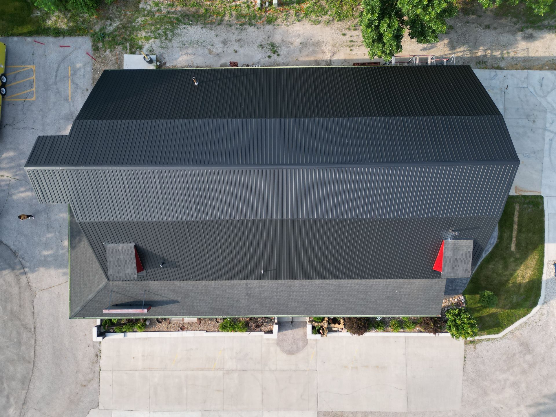 An aerial view of a large building with a black roof.