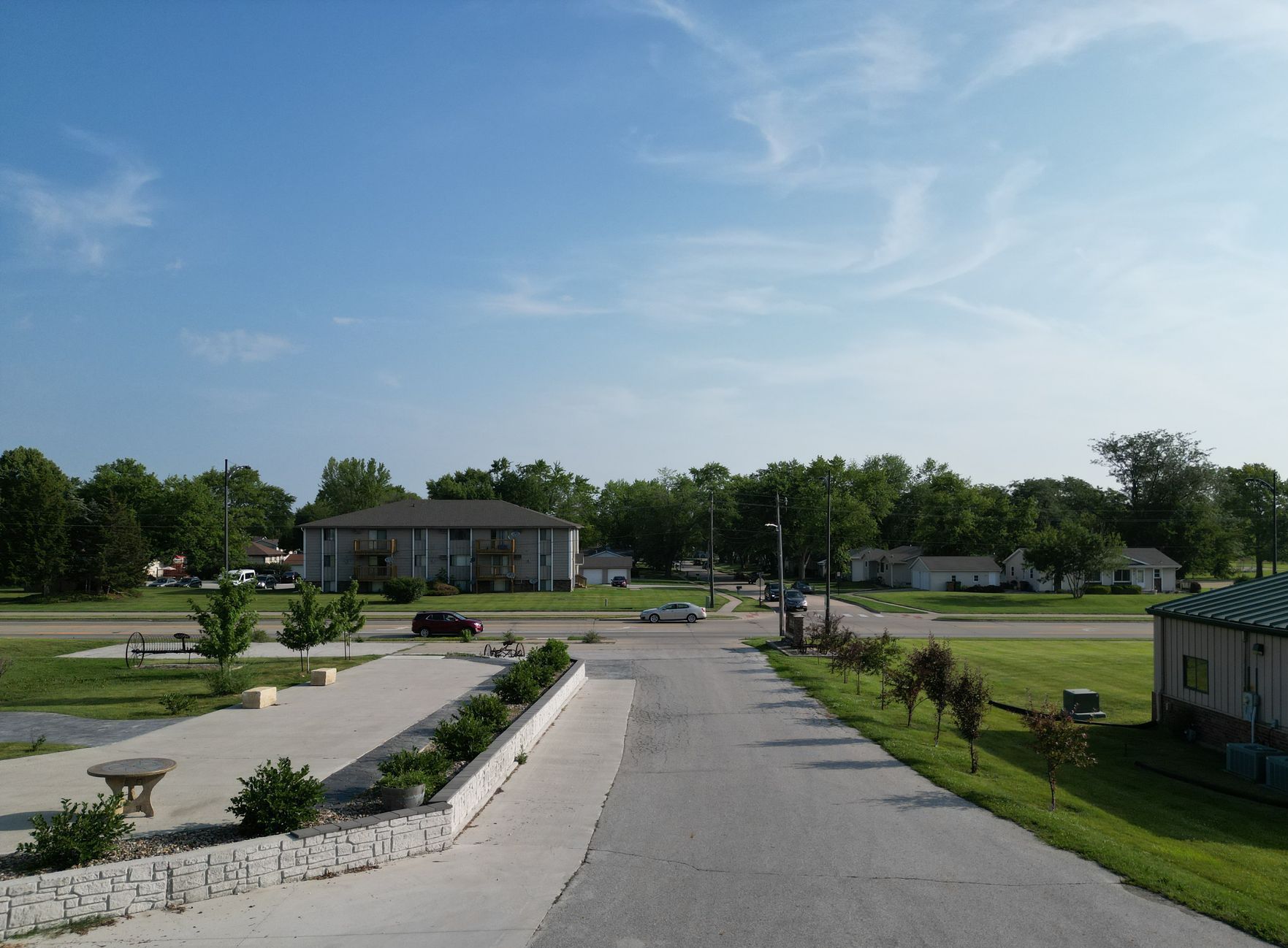 A road leading to a house with a blue sky in the background