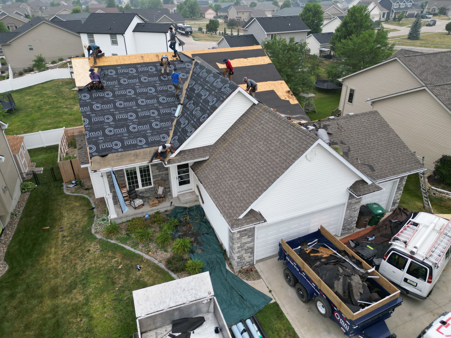 An aerial view of a roof being installed on a house