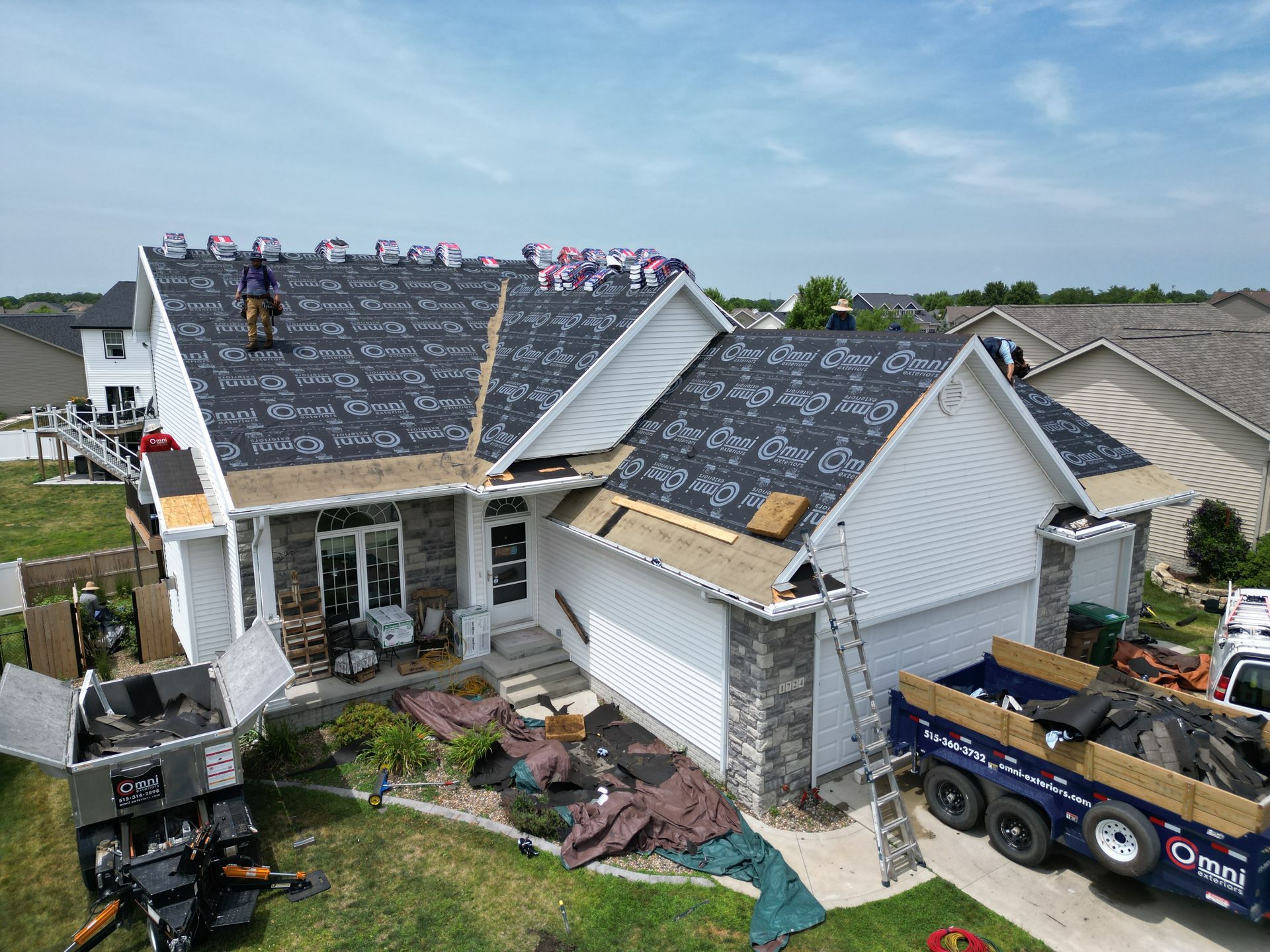 An aerial view of a house under construction with a truck parked in front of it.