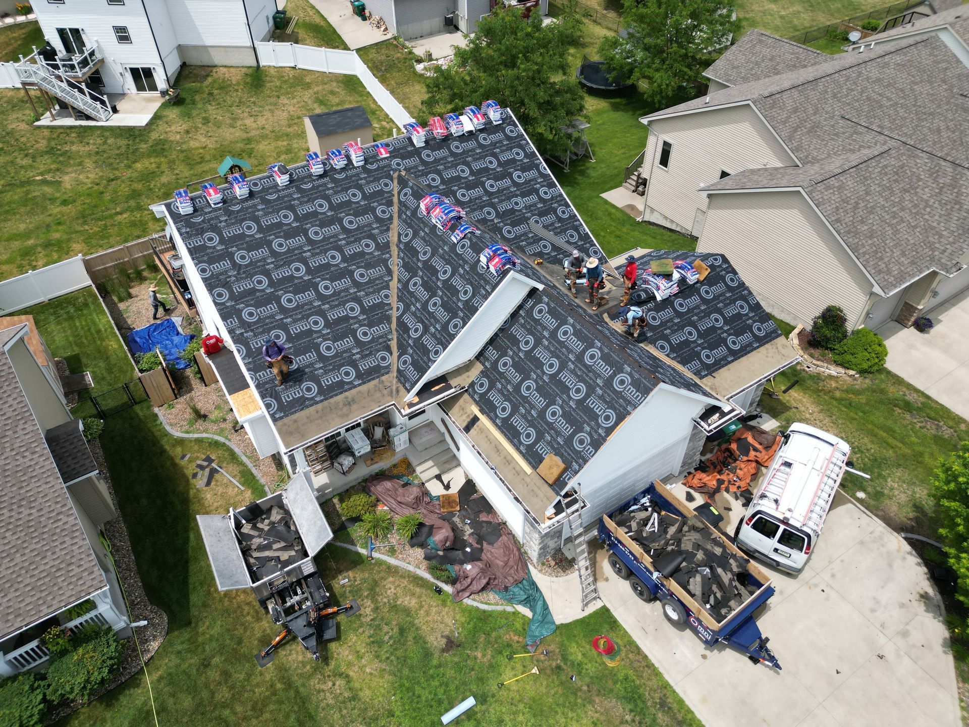 An aerial view of a roof being installed on a house.